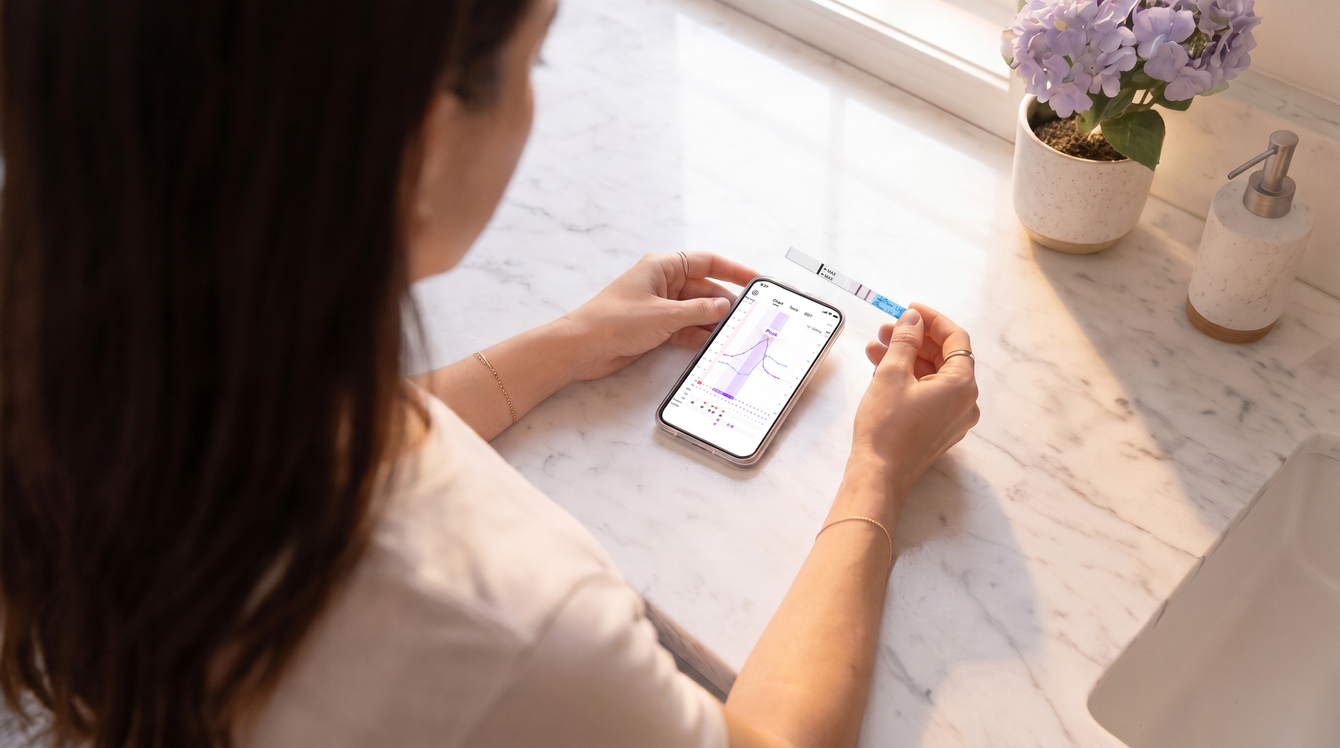Woman reviewing her cycle data in the Premom app